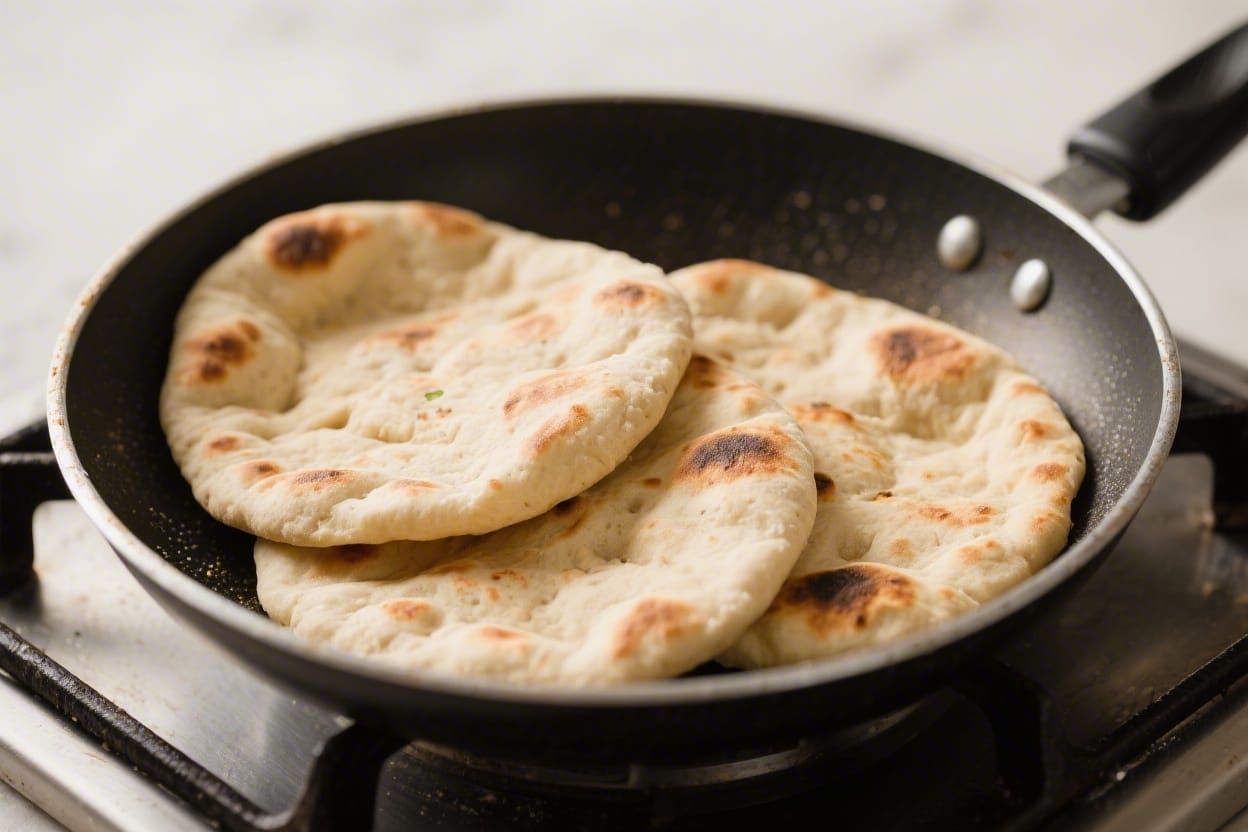 Easy stovetop naan bread recipe - You’ll mix a simple dough, let it rest, and cook each piece in a hot skillet